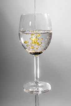 clear long stem wine glass with yellow liquid